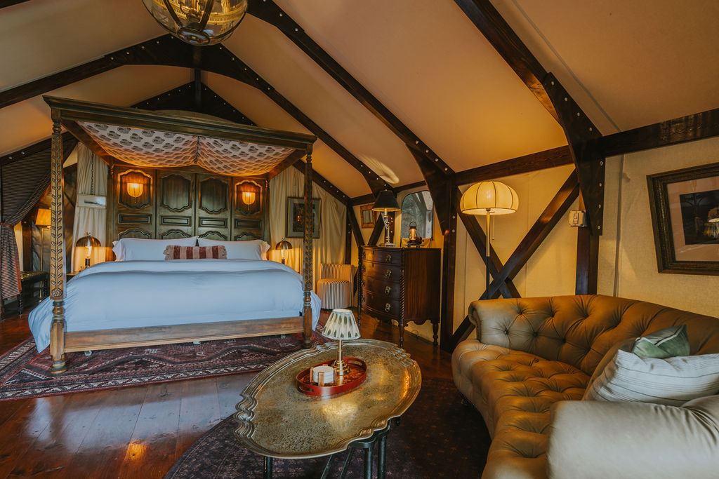South Camp bed dressed in white linens beneath the canvas roof