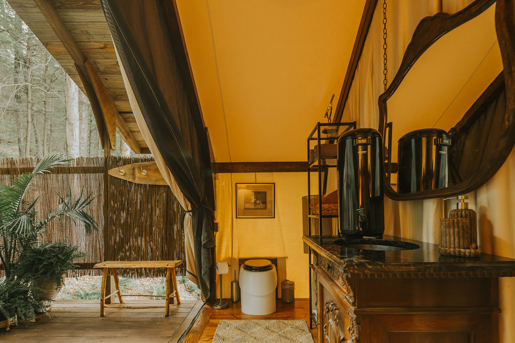 Timber framing and peaked canvas ceiling inside South Camp