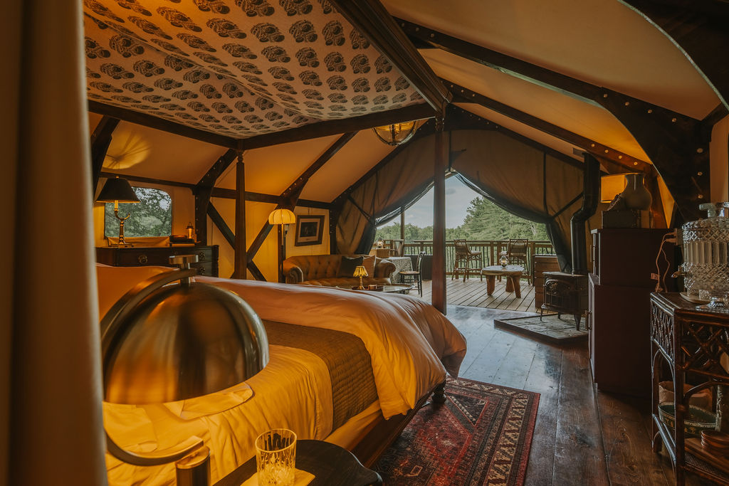 South Camp bedroom with armchair and reading lamp