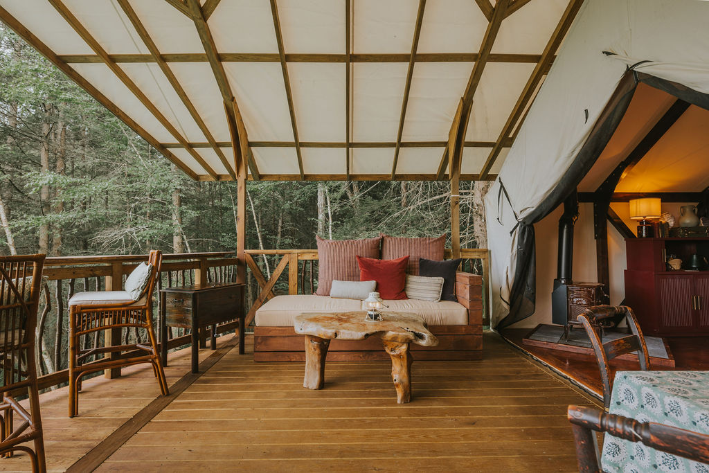 South Camp deck with dining table overlooking the woods