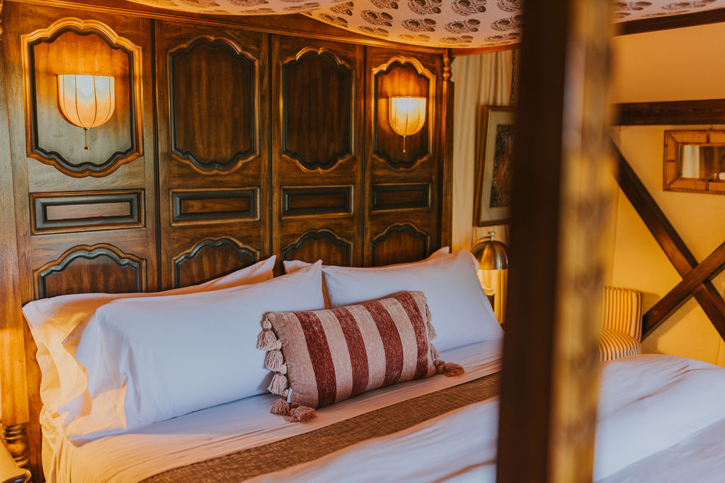 Close view of the bed linens and cushions in South Camp